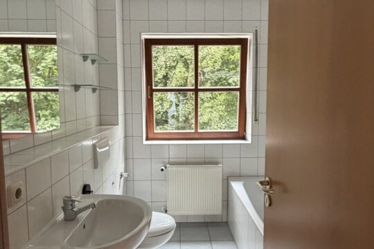 Badezimmer mit Dusche und Badewanne und Fenster